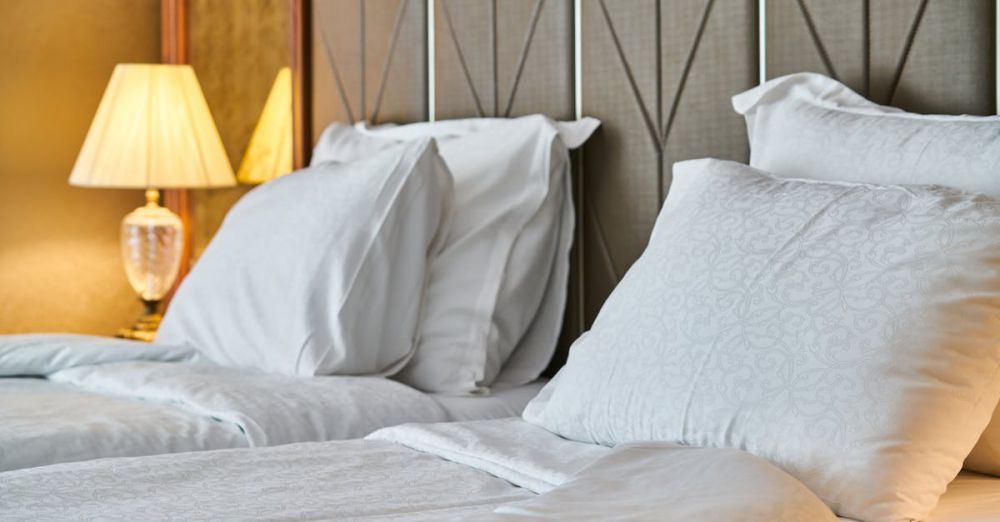 Beds - Inviting hotel room with comfortable bedding and ambient lighting, perfect for relaxation and luxury stay.