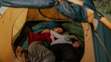 Sleeping Bags - A cozy moment of a couple cuddling inside a tent, reflecting outdoor relaxation.