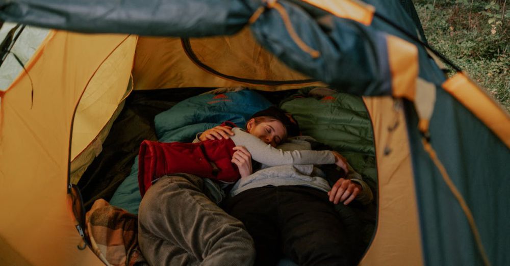 Sleeping Bags - A cozy moment of a couple cuddling inside a tent, reflecting outdoor relaxation.