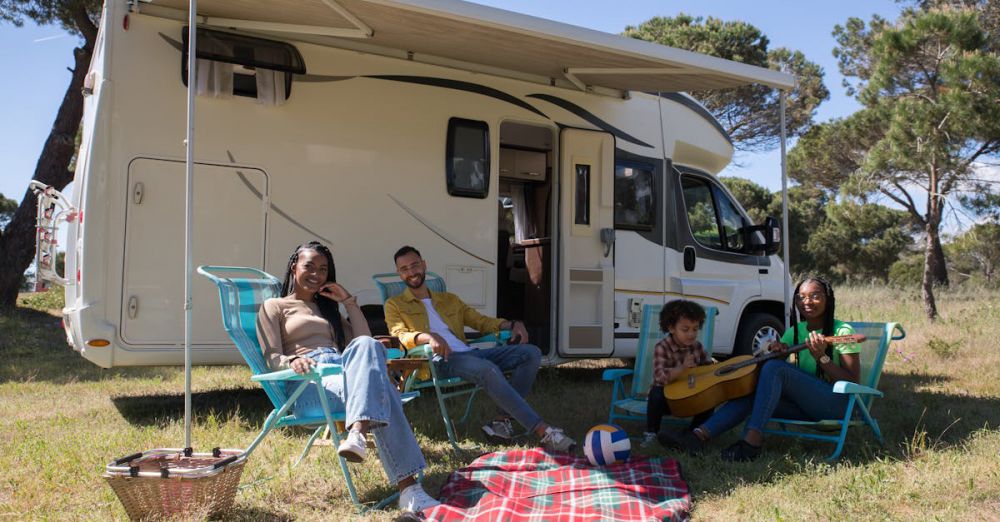 Camping Chairs - Smiling family enjoying a camping trip in Portugal with their campervan, relaxing with leisure activities.