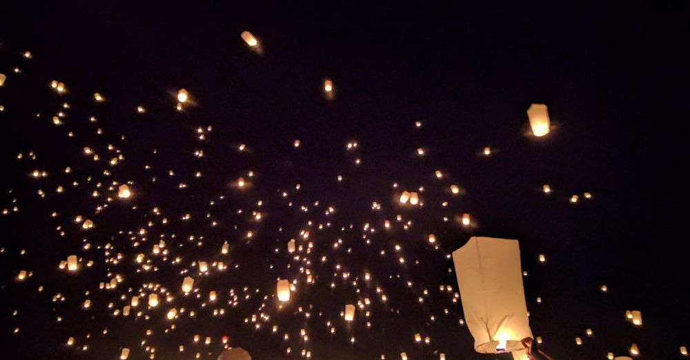 Lanterns - A breathtaking view of floating lanterns illuminating the night sky during a vibrant festival.