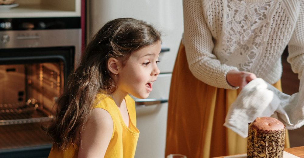 Cooking Tools - A mother and daughter bond while baking a colorful Easter cake in a cozy kitchen setting.