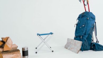 Trekking Poles - A collection of hiking gear including a backpack, map, and chair for winter expeditions.