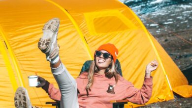 Folding Shovels - Warmly-clothed woman enjoying sunny day outdoors near a vibrant yellow tent