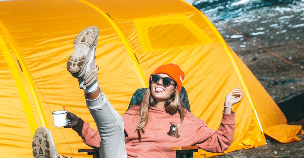 Folding Shovels - Warmly-clothed woman enjoying sunny day outdoors near a vibrant yellow tent