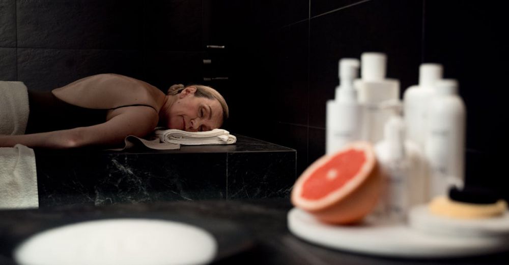 Moisturizers - Senior woman relaxing in a spa setting with body care products nearby, embracing tranquility and self-care.