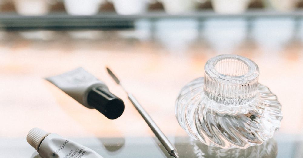 Makeup Removers - A chic arrangement of beauty tools on a glass table inside an upscale salon.