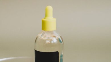 Vitamin C Serums - Close-up of essential oil dropper on pastel dish, perfect for beauty and wellness themes.