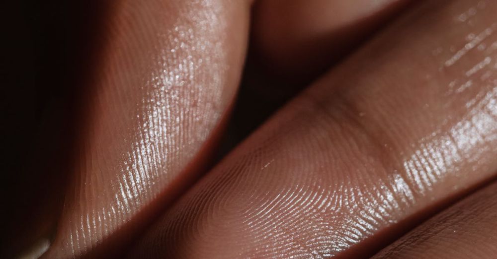 Oily Skin Products - Close-up shot of fingers with smooth skin, showing delicate texture and light reflection.