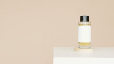 Hair Serums - A sleek cosmetic bottle with blank label on a clean white platform against a neutral background.