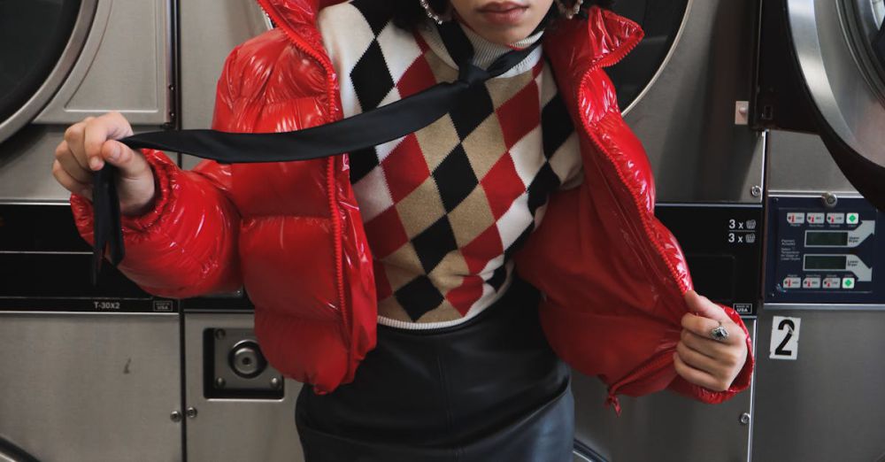 Hair Dryers - Stylish woman in laundromat wearing a bold red jacket and leather skirt.