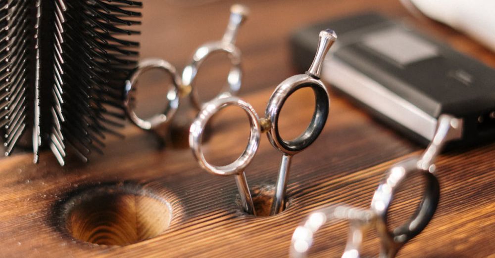 Styling Tools - Close-up of professional hairdressing equipment on a wooden salon table, ready for use.