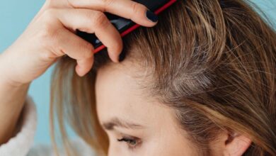 Scalp Treatments - A woman brushing her hair showing hair texture and care.