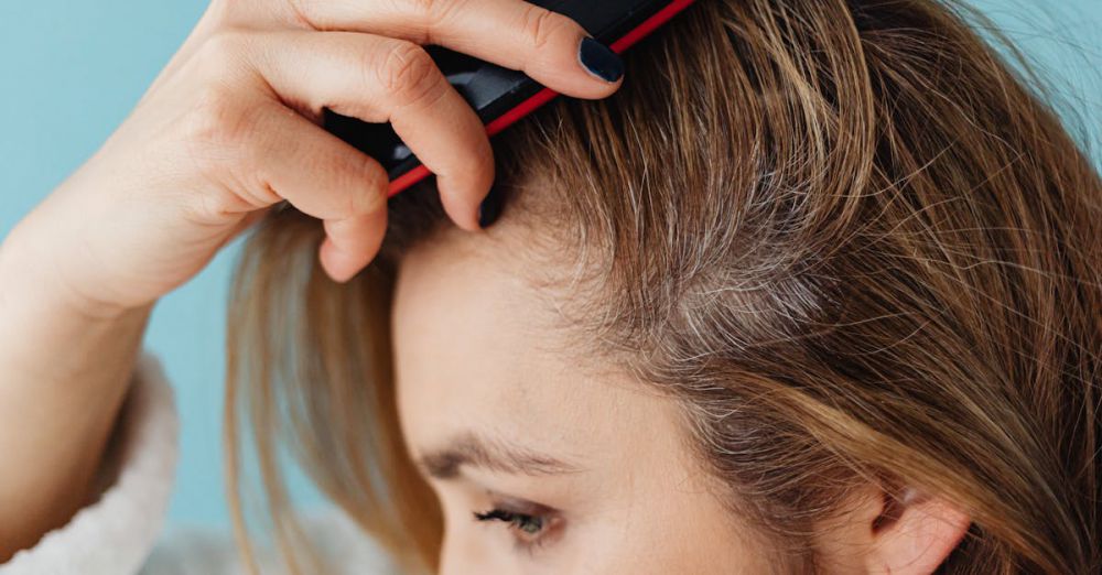 Scalp Treatments - A woman brushing her hair showing hair texture and care.