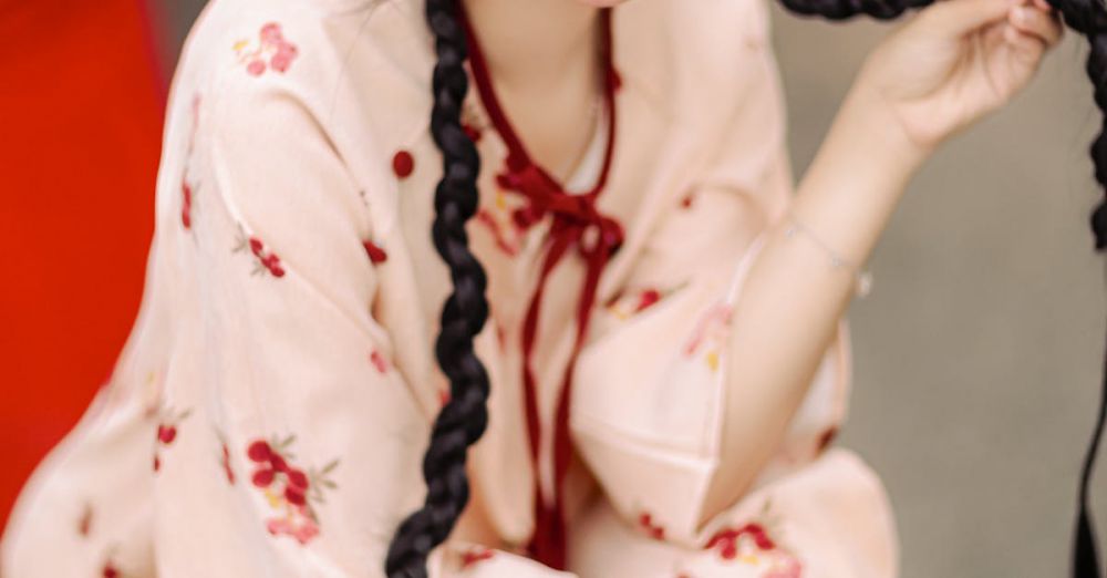 Hair Accessories - Smiling woman in floral dress with braids holding pomegranate basket, evoking tradition and joy.