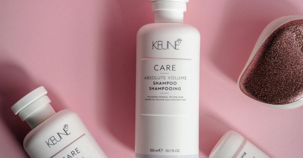 Volume Products - Stylish display of Keune hair care products on a pink background, emphasizing elegance and luxury.