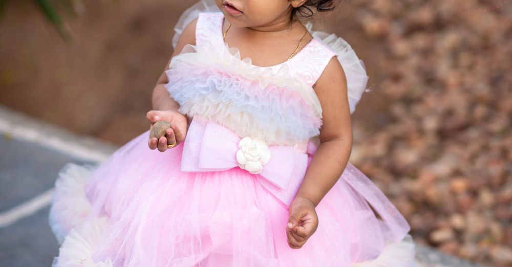 Hair Clips - Charming toddler in a pastel pink dress walking outside. Perfect for family-themed visuals.