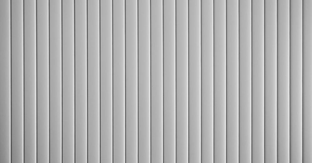 Flat Irons - A close-up view of a corrugated metal texture with vertical stripes, ideal for backgrounds.