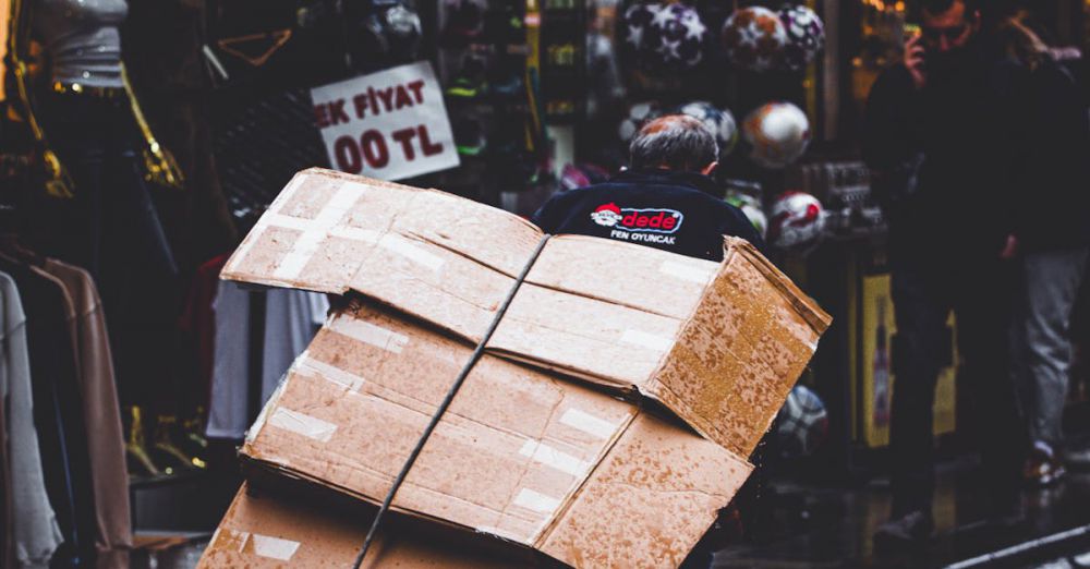 Subscription Boxes - A street vendor hauls boxes through a lively market street in İstanbul, Türkiye.