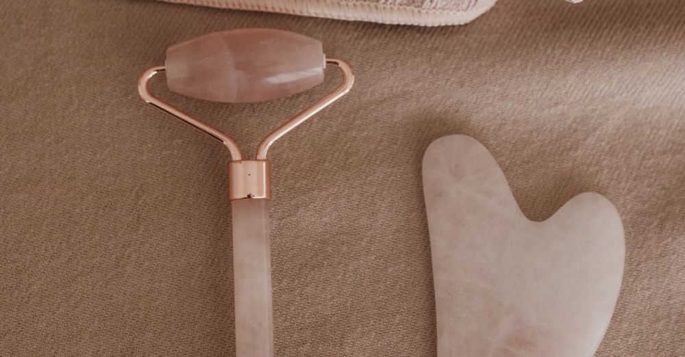 Spa Kits - Flat lay of a rose quartz skincare tool set and towels for a wellness routine.