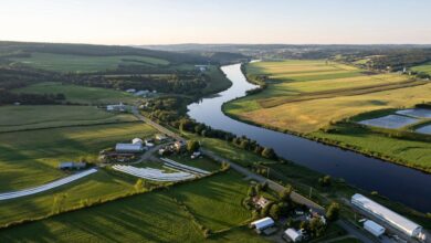 Roll-Ons - Drone capture of Quebec's picturesque farmland along a winding river at sunset.