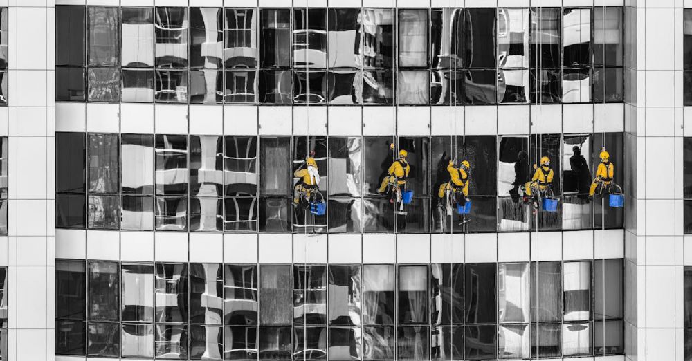 Cleaners - High-rise window cleaners in Dubai cleaning a skyscraper, showcasing urban architecture.