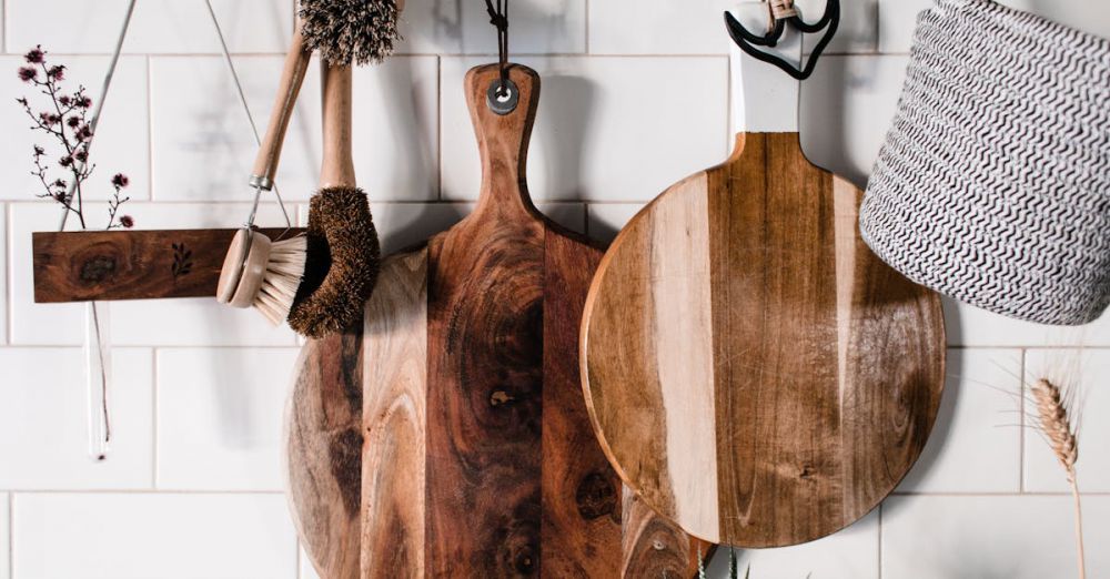 Cleaning Brushes - Charming wooden kitchenwares hang stylishly on a white tiled wall, perfect for rustic decor.