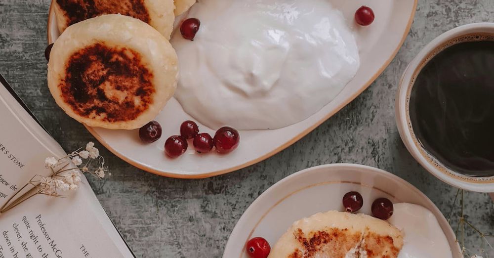 Odor Products - Cozy breakfast scene featuring traditional syrniki with cranberries, yogurt, and a hot cup of coffee.