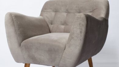 Upholstery Products - A stylish gray armchair with wooden legs photographed on a white background.