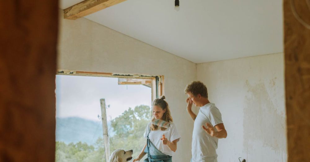 Window Tools - Happy couple and dog renovating their home, enjoying a playful moment indoors.