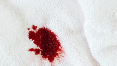 Stain Removers - A close-up view of a red stain on a white towel, highlighting laundry challenges.