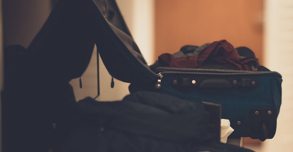 Packing - A warm-toned indoor image of an open suitcase with clothes, conveying travel readiness.