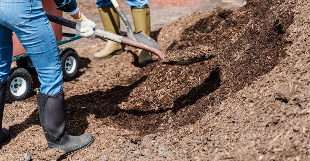 Gardening Shovels - Two workers spreading soil outdoors, emphasizing teamwork and gardening efforts.