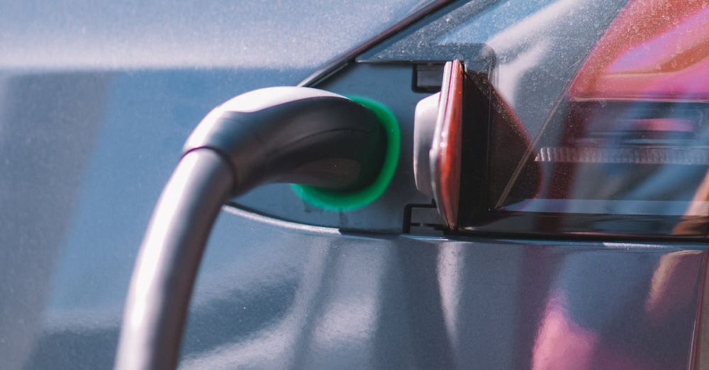 Chargers - Close-up of an electric car plugged into a charging station, showcasing modern technology.