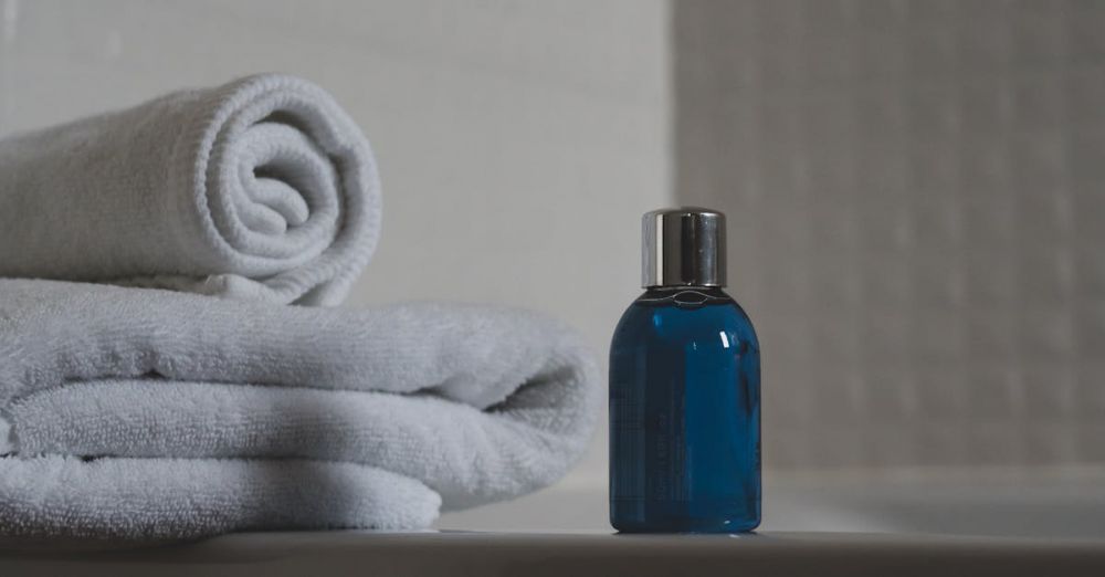 Toiletries - Luxurious white towels and blue bottle create a tranquil spa atmosphere.