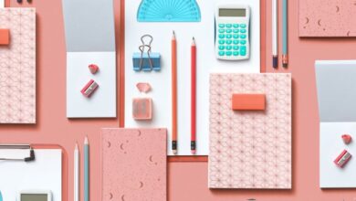 Stationery Sets - Colorful assortment of stationery items arranged on a pink background in a flat lay style.