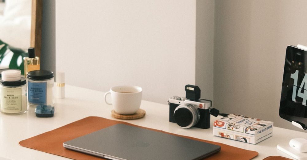 Desk Accessories - A clean and minimalist home office desk featuring a laptop, camera, and modern accessories.