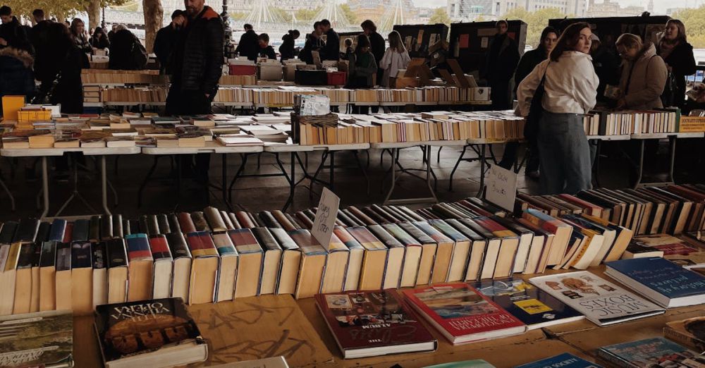 Reading Stands - An outdoor book market with tables of books and numerous shoppers enjoying a lively atmosphere.