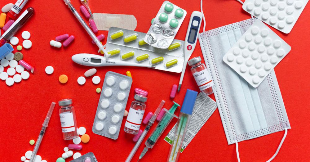 Thermometers - Medical supplies and medications displayed on a red background, emphasizing healthcare essentials.