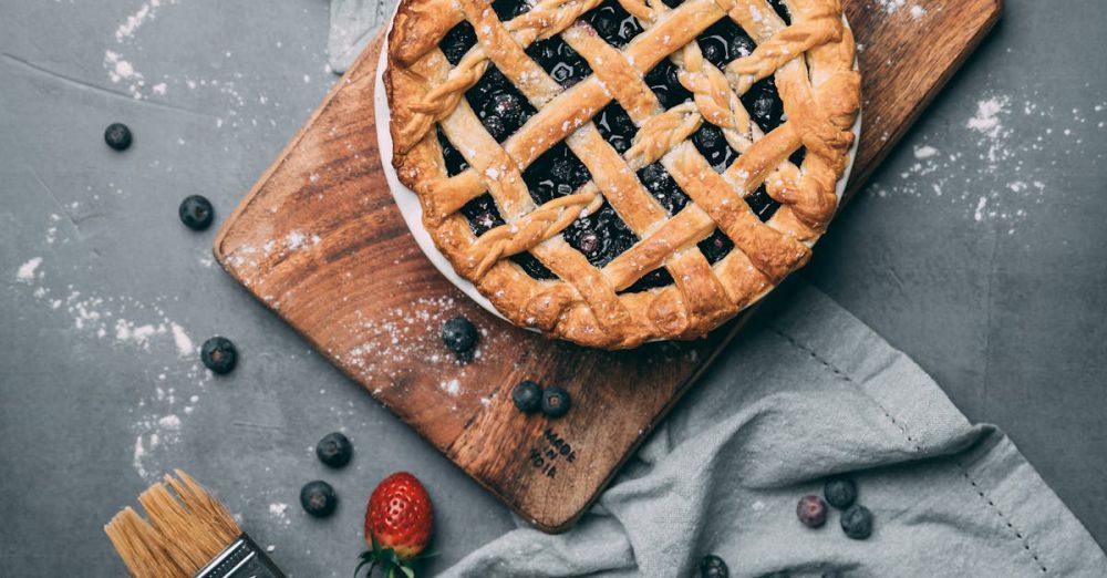 Pastry Brushes - Delicious homemade blueberry pie with fresh strawberries on a rustic wooden board.