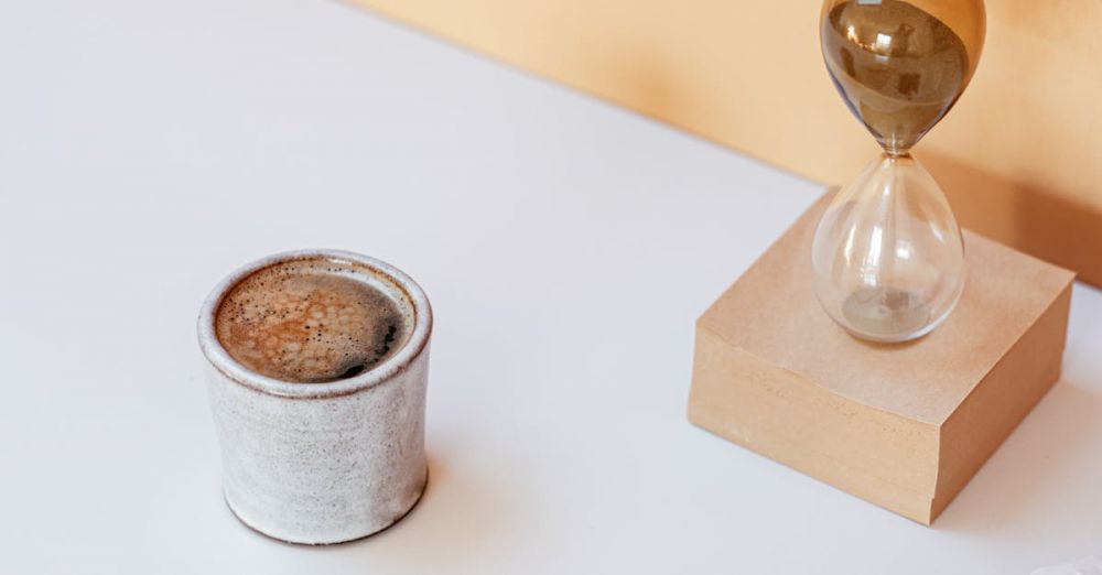 Kitchen Timers - Artistic composition featuring coffee, an hourglass, and scattered coffee beans on a table.