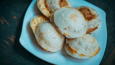 Dough Products - A close-up view of freshly baked bread pieces on a white plate, ideal for food photography.