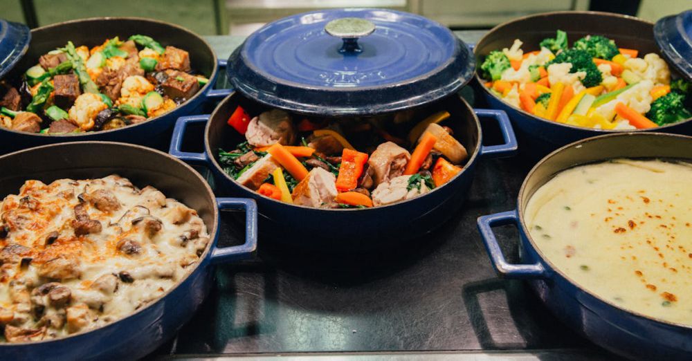 Casserole Dishes - An array of delicious dishes in blue cooking pots, perfect for dinner or a buffet setup.