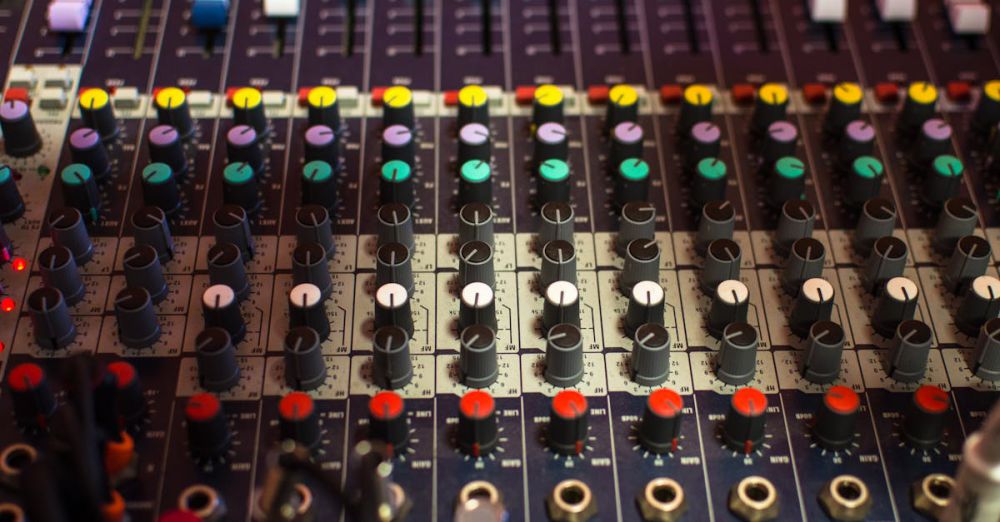 Electric Mixers - Detailed view of a professional audio mixing console with multicolored knobs in a studio setting.