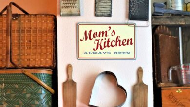 Graters - Charming kitchen wall decor featuring vintage graters, signs, and baskets in a cozy setting.