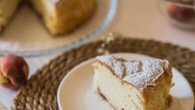 Baking Mats - A delightful slice of homemade peach cake served on a plate with whole peaches nearby.