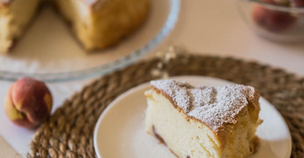 Baking Mats - A delightful slice of homemade peach cake served on a plate with whole peaches nearby.