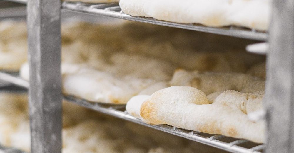 Cooling Racks - Close-up of freshly baked bread cooling on racks in a bakery.