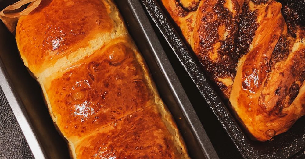 Bread Pans - Delicious homemade sweet breads cooling in trays, perfect for a cozy treat.