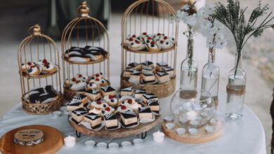 Cake Stands - Chic dessert table with birdcage cake displays, sweets, and floral decor for a stylish celebration.